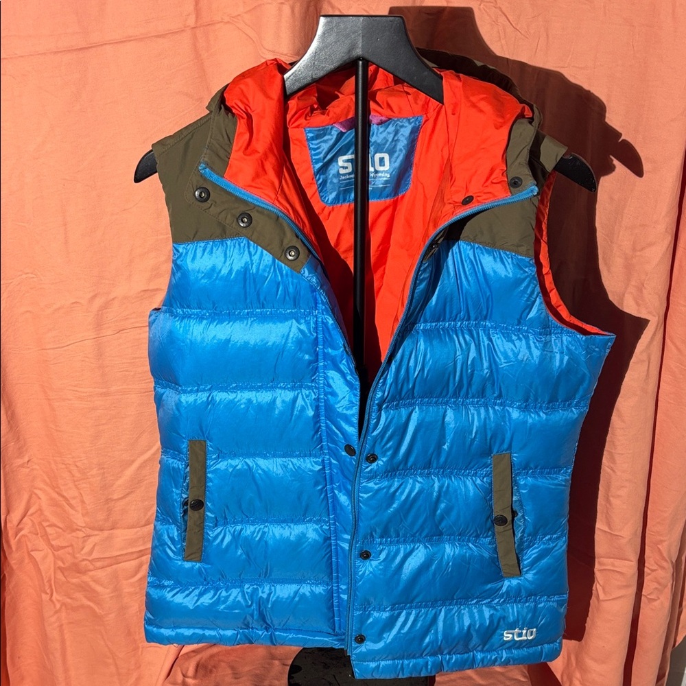 Stio Bright Blue Puffer Vest with Red and Green and Brown Accents